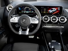 the interior of a mercedes c - class sedan with its steering wheel and dashboard controls