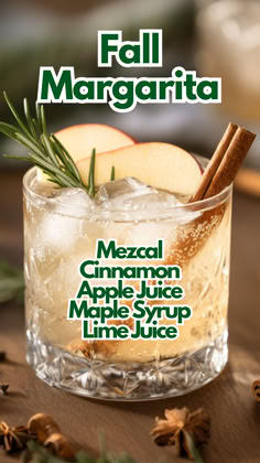 a glass filled with ice and cinnamon on top of a wooden table