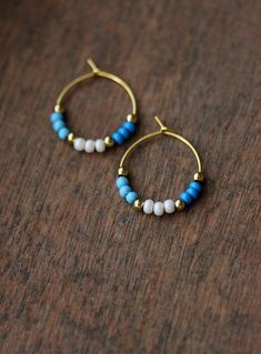 Minimalist summer earrings with bright blue, light blue, white glass seed beads,small gold tone beads and gold tone stainless steel round hoop earrings. Earring hooks are from nickel free and lead free metal. Perfect jewelry for everyday wear or a great gift for someone special! Diameter of hoops is 20 mm Other earrings of my shop you can see here: https://www.etsy.com/shop/NaTavelli?section_id=13757927 Thanks for visit. Beaded Earrings Hoop, Blue And White Beaded Earrings, Blue Dangle Hoop Earrings With Tiny Beads, Blue Small Hoop Earrings With Tiny Beads, Blue Small Hoop Beaded Earrings For Summer, Blue Hoop Beaded Earrings With Tiny Beads, Handmade Minimalist Blue Hoop Earrings, Blue Handmade Minimalist Hoop Earrings, Blue Small Hoop Earrings For Summer