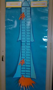 a door decorated with an image of a tall tower and orange fish on it's growth chart