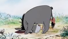 an animated image of a rhinoceros and a fish in the sand with grass