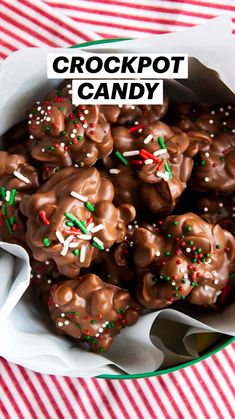 a bowl filled with chocolate covered pretzels on top of a red and white table cloth