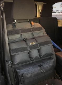 the back seat of a car with luggage strapped to it's rear end and side pocket