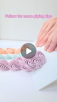 a person is cutting some pink icing on a white surface with their fingers and thumbnails