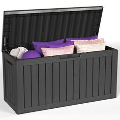 a large storage box with purple and white pillows