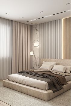 a large bed sitting in the middle of a bedroom next to a wall mounted light