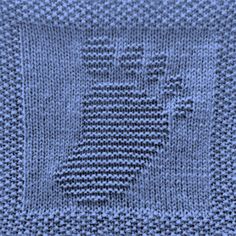 a blue knitted blanket with the letter e on it's side and an image of a building in the middle