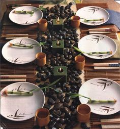 the table is set with white plates and bamboo placemats that are arranged on top of each other