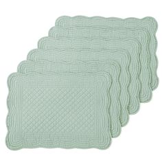 four green placemats on a white background