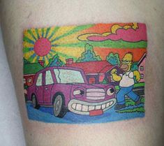 the simpsons car is painted on this man's arm