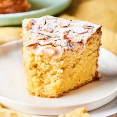 a piece of cake sitting on top of a white plate next to a bowl of cookies