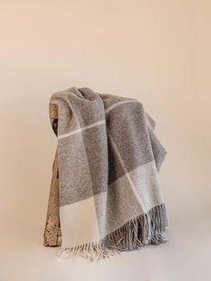 a grey and white checkered blanket sitting on top of a table