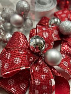 a red bow with silver ornaments around it