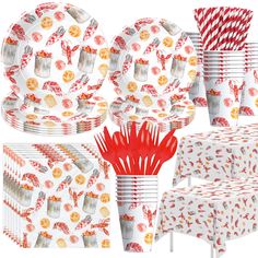 a table set with red and white paper plates, napkins, cups, and utensils