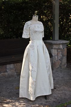 a dress on display in front of a bench