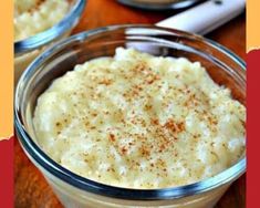 two bowls filled with mashed potatoes on top of a wooden table