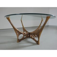 a glass and wood table with an intricate design