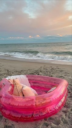 an inflatable mattress is on the beach