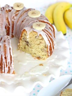 a bundt cake with white icing and banana slices on it next to sliced bananas