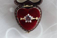 an engagement ring in a heart shaped box