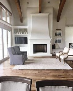 a living room with two chairs and a fireplace