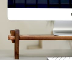 a computer monitor sitting on top of a wooden desk