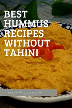 the best hummus recipes without tahitii on a blue and white plate with green leaves in the background