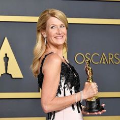 a woman holding an award in her hand