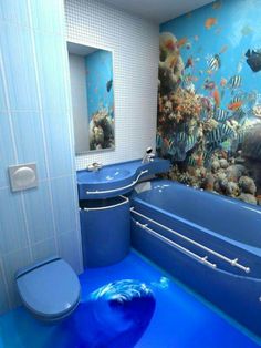 a bathroom with an aquarium in the floor and a bathtub next to it,