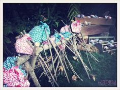 a pile of clothes sitting on top of a grass covered field next to a wooden bench