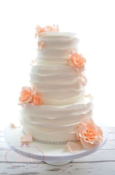 a white wedding cake with orange flowers on it