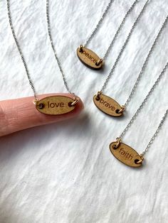 "Materials: - wooden \"faith\" or \"brave\" or \"love\" or \"peace\" charm  - oxidized 925 sterling silver chain, 14k gold fill wire & 14k gold fill findings Dimensions: - wooden bar measures approximately 10mm across; 5mm high & 3mm thick - the chain includes the findings and the bar laying on a flat surface Presentation: - I wrap all items with care and are ready to be gifted or enjoyed immediately. I also include product information to help tell the story of the piece  A Little About Me: - I Laser Cut Necklace, Wood Jewelery, Mixing Metals, Laser Cut Jewelry, Laser Projects, Handmade Boutique, Necklace Love, Laser Ideas, Wood Necklace