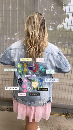 the back of a woman's jean jacket with words written on it and flowers