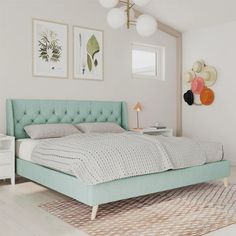 a bedroom with a bed, rug and two pictures on the wall above it that have been decorated in pastel colors