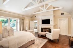 a bedroom with a large bed and fireplace in it