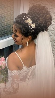 a woman in a wedding dress looking at herself in the mirror with her hair pulled back