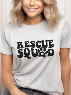 "Wear your heart on your sleeve with our \"Rescue Squad\" adult shirt featuring an adorable dog paw graphic. Perfect for dog lovers, rescue advocates, shelter supporters, and proud rescue dog Moms and Dads. Let this shirt be a testament to your love and dedication to saving our furry friends. A portion of the proceeds from this shirt goes towards supporting dog rescue efforts. Join the squad and make a difference! 🐾🐶 This classic unisex jersey short sleeve tee fits like a well-loved favorite. Cute Dog Shirts, Dog Shirt Ideas, Dog Rescue Shirts, Animal Rescue Shirt, Dog Mama Shirt, Dog Mom Tee