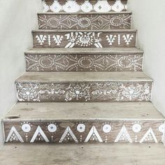 the stairs are decorated with white and brown designs