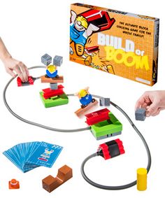 the build or boom board game is being played by two hands, with several blocks and pieces in front of it