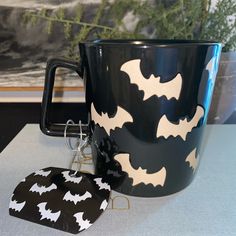 a batman themed mug and keychain on a table