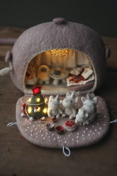 there is a small stuffed animal set in the bag with its lights on and other decorations