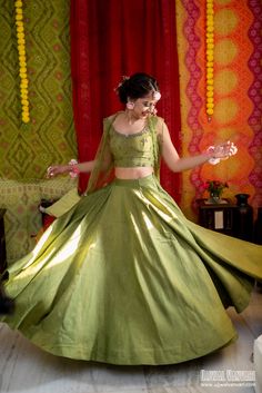 a woman in a green dress is dancing