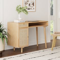 a wooden desk with a plant on top of it