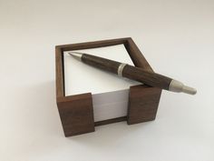 a pen and paper in a wooden box