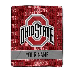 a red and gray blanket with the word ohio state on it, in front of a white background