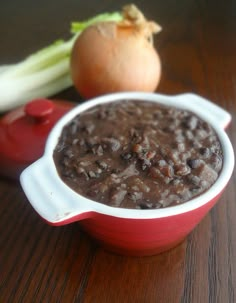 a close up of a bowl of food on a table with onions and celery