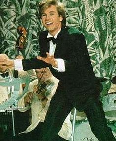 a man in a tuxedo and bow tie is dancing