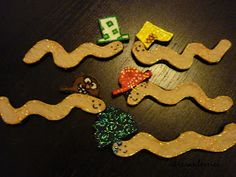 some wooden toys are laying on a table with water and sea animals in it's waves