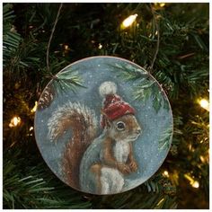 a squirrel ornament hanging from a christmas tree