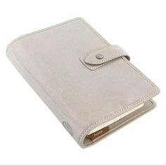 a white leather wallet with a button on the front